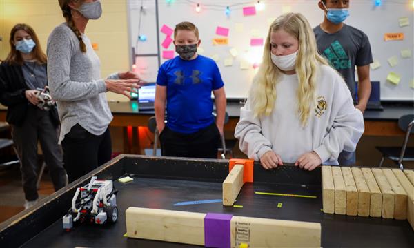 Students place robots on table